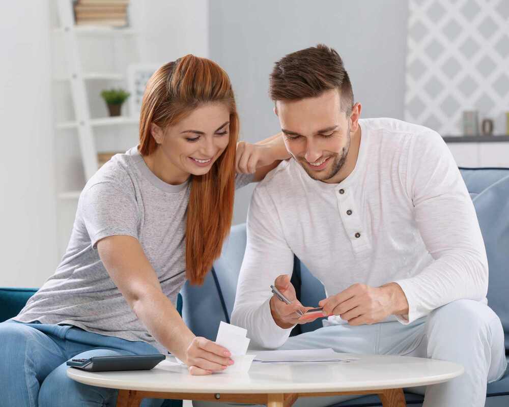 A happy couple looking at small pieces of white paper