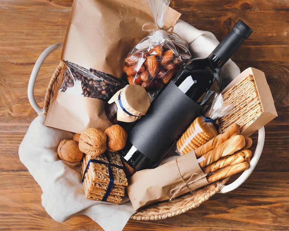 Gift basket filled with wine, crackers, breadstick, jams and more