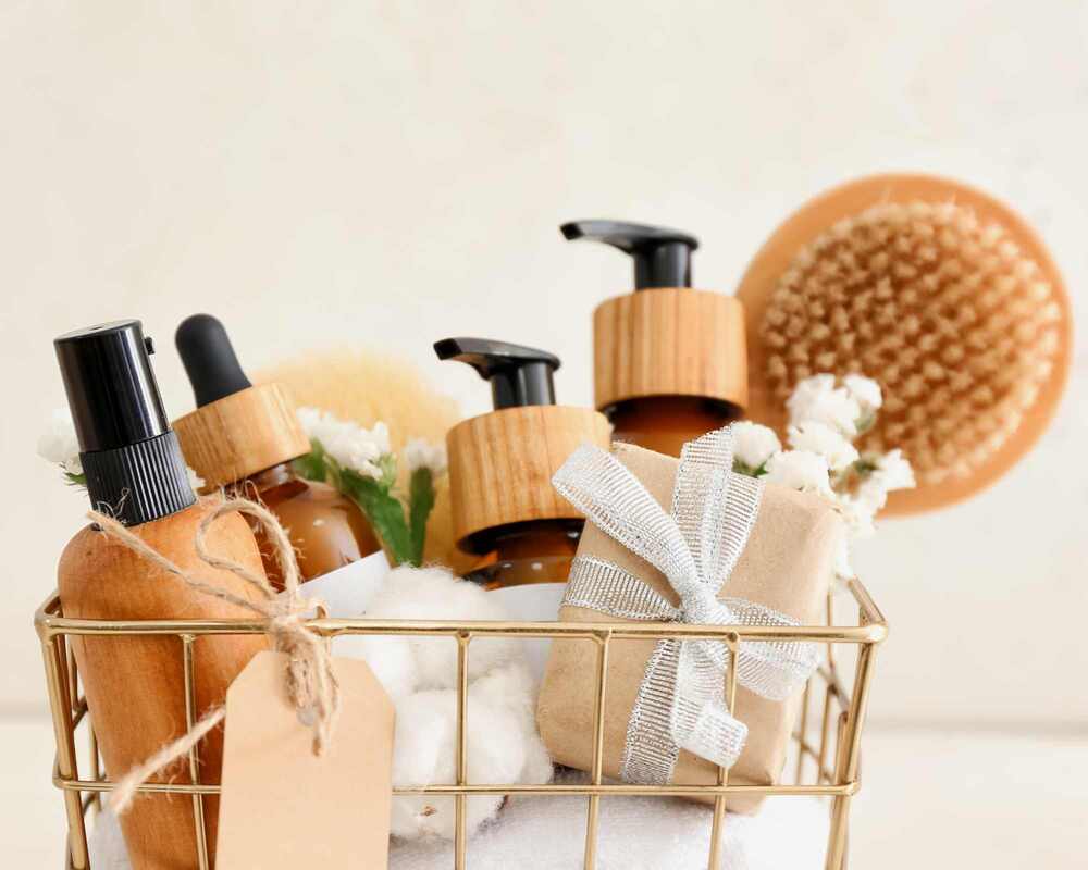 Gift basket filled with pamper products, a hairbrush and soaps
