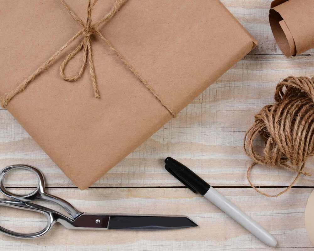 Scissors, twine, kraft paper and a pen, used to make Hens Night Pass the Parcel