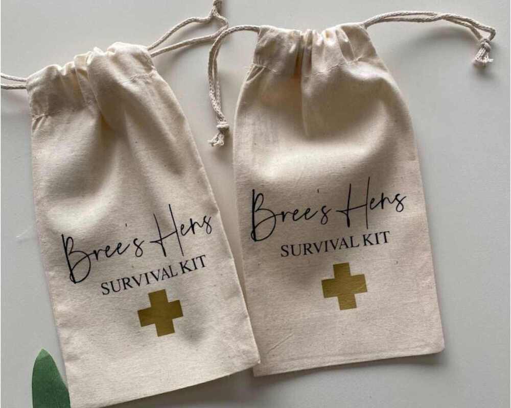 Two small calico bags with the words 'Bree's Hens Survival kit' printed on the front