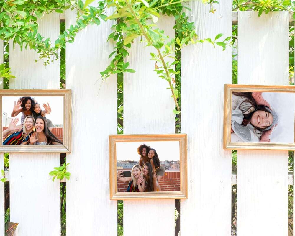 Decorate with Photos - Framed pictures mounted on a white fence