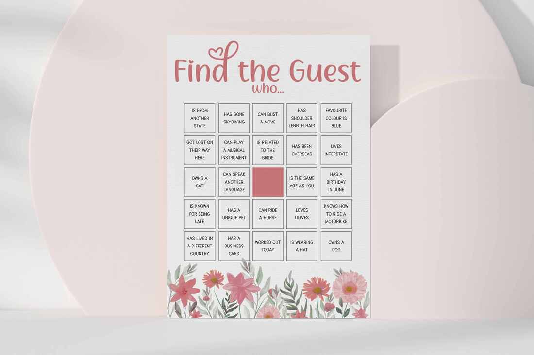 Pink floral themed find the guest bingo game card leaning against pink circles