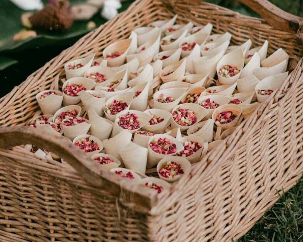 Flower confetti in confetti cones. The cones are placed in a large basket