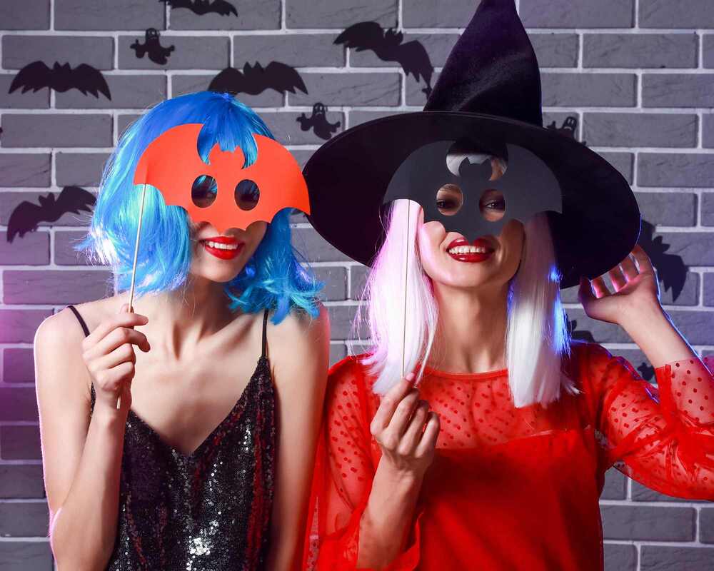 Two women dressed up in a Halloween photobooth