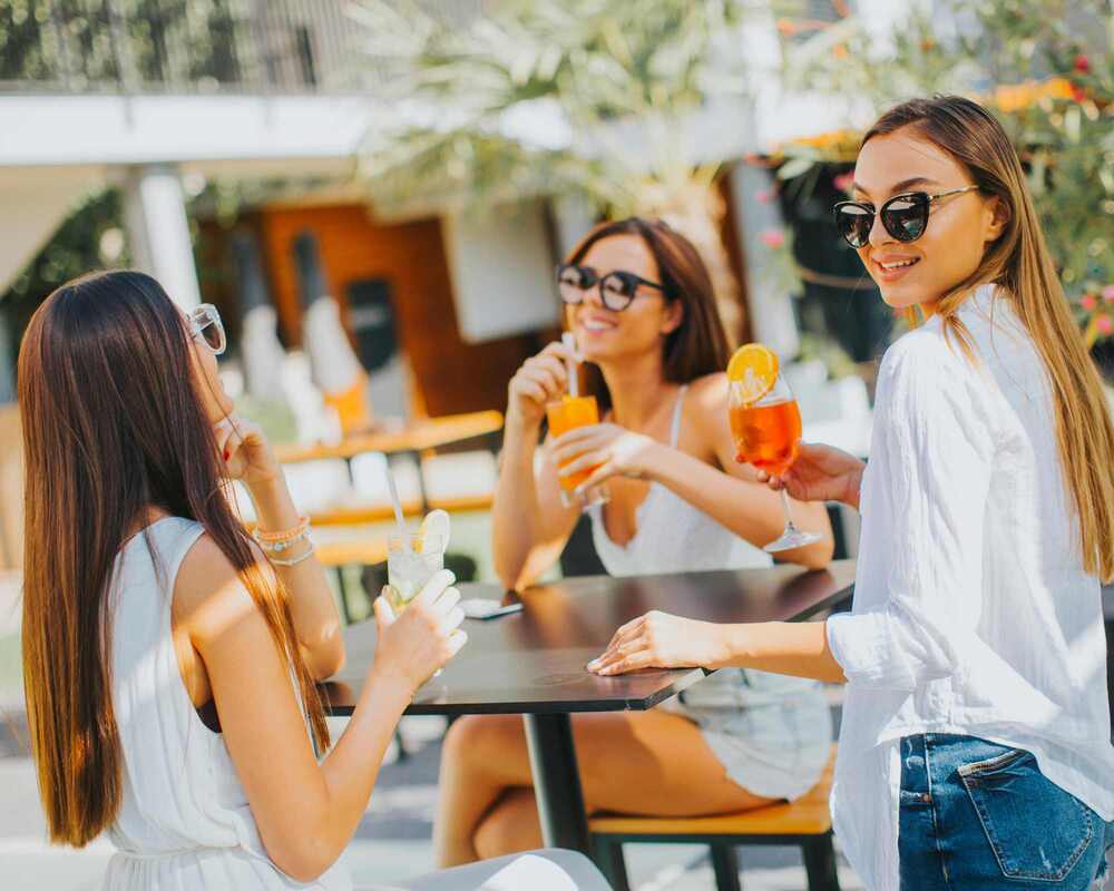 Women drinking cocktails at a bar
