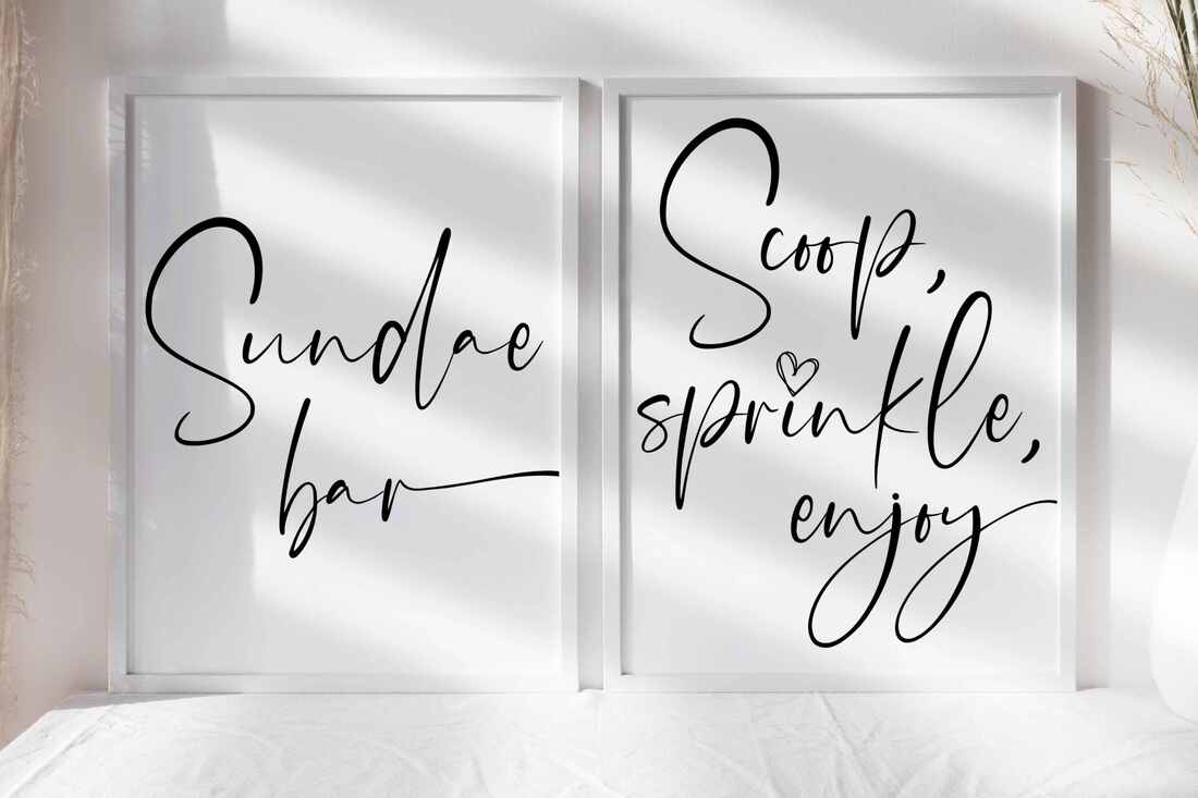Two framed signs, one saying 'sundae bar', the other saying 'scoop, sprinkle, enjoy'