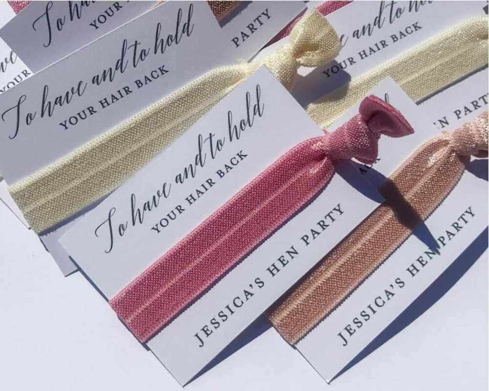 Hairties attached to a piece of card that says 'to have and to hold your hair back'