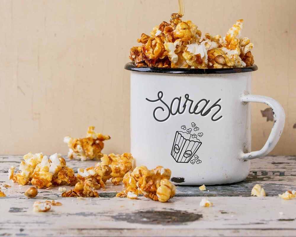 Popcorn coated in honey overflowing from a personalised mug