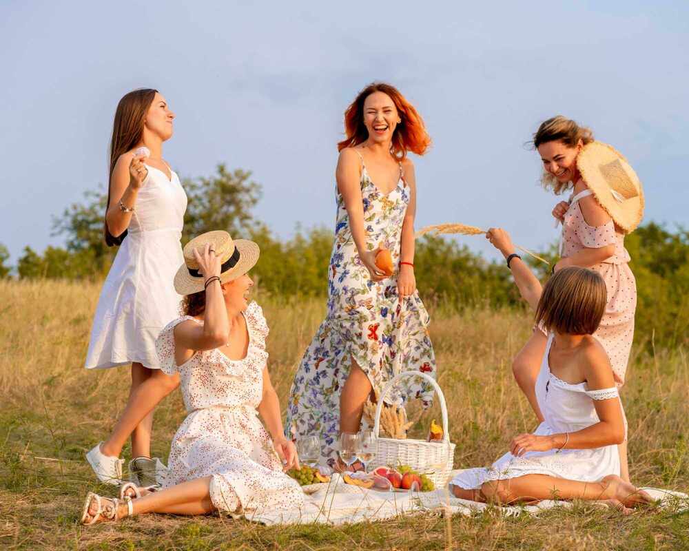 The Best Picnic Ideas - picture of women at a picnic who are smiling and laughing