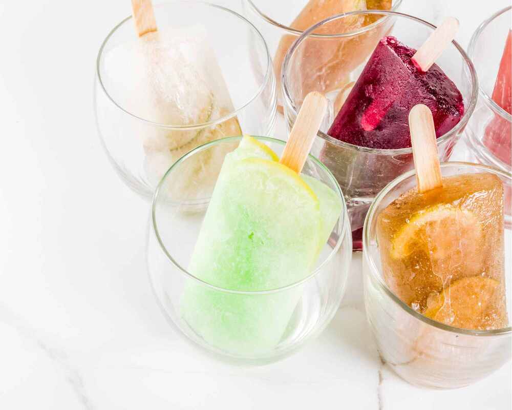 Boozy popsicles placed into glasses